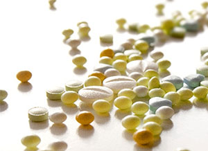 Various pills on a white counter.