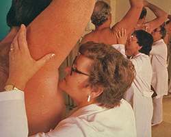 A laboratory armpit smelling experiment, with a line of men with their arms up and a line of women smelling their pits.