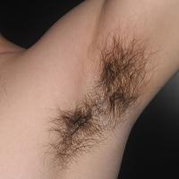 Someone raising their arm to show off armpit hair