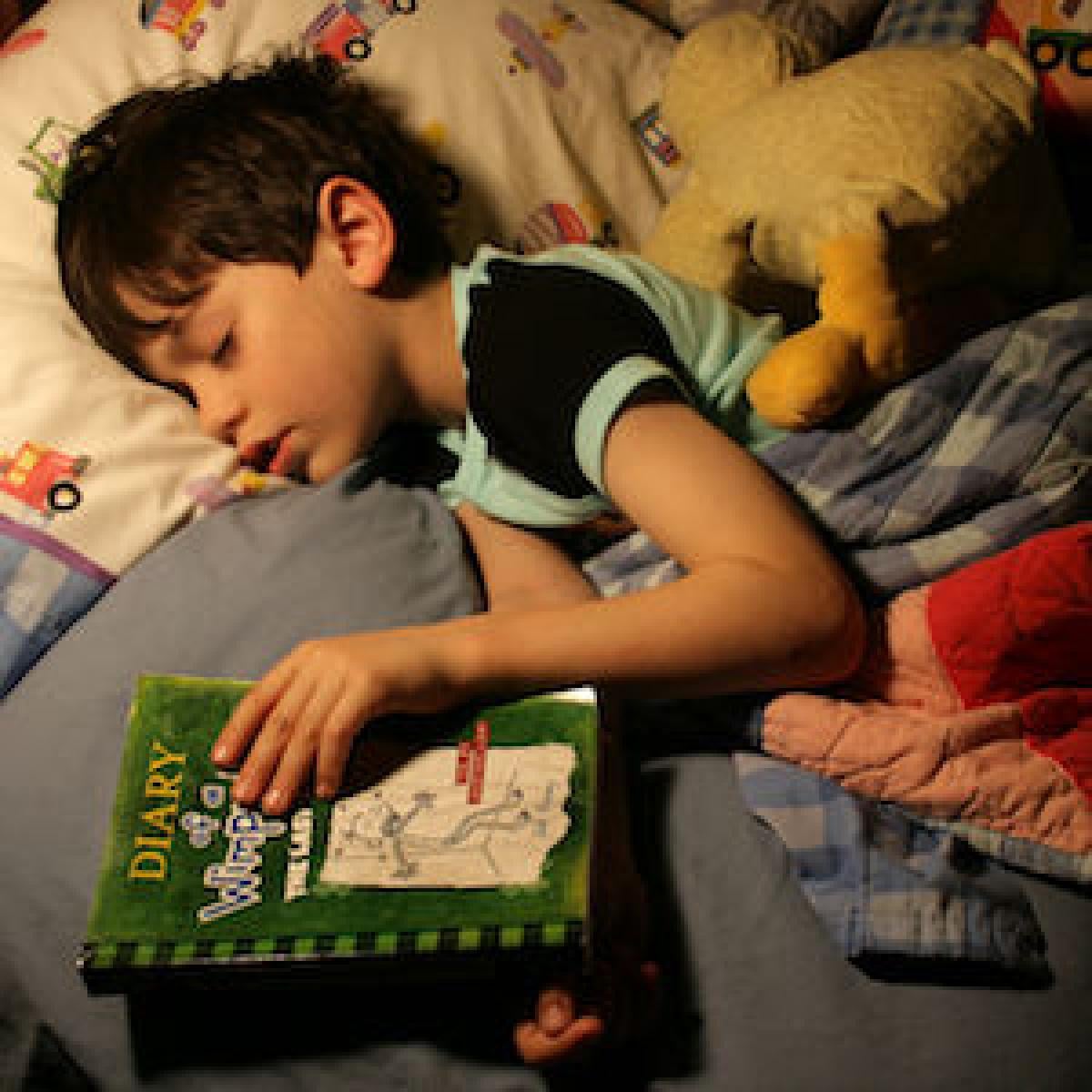 Picture of a child who fell asleep while reading Diary of a Wimpy Kid