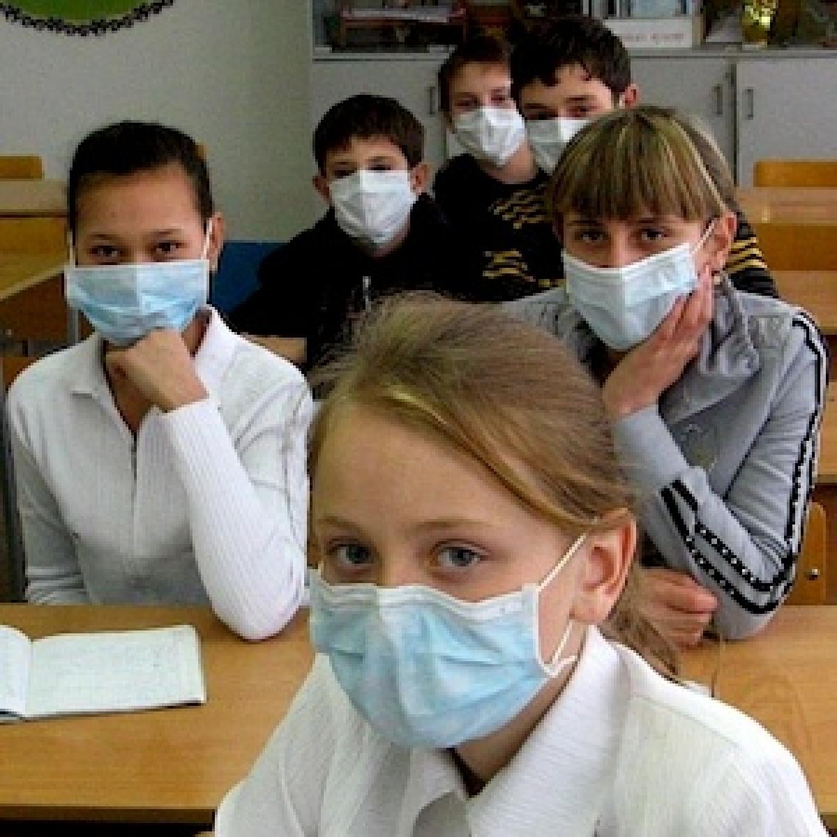 Children wearing masks to protect against airborne disease