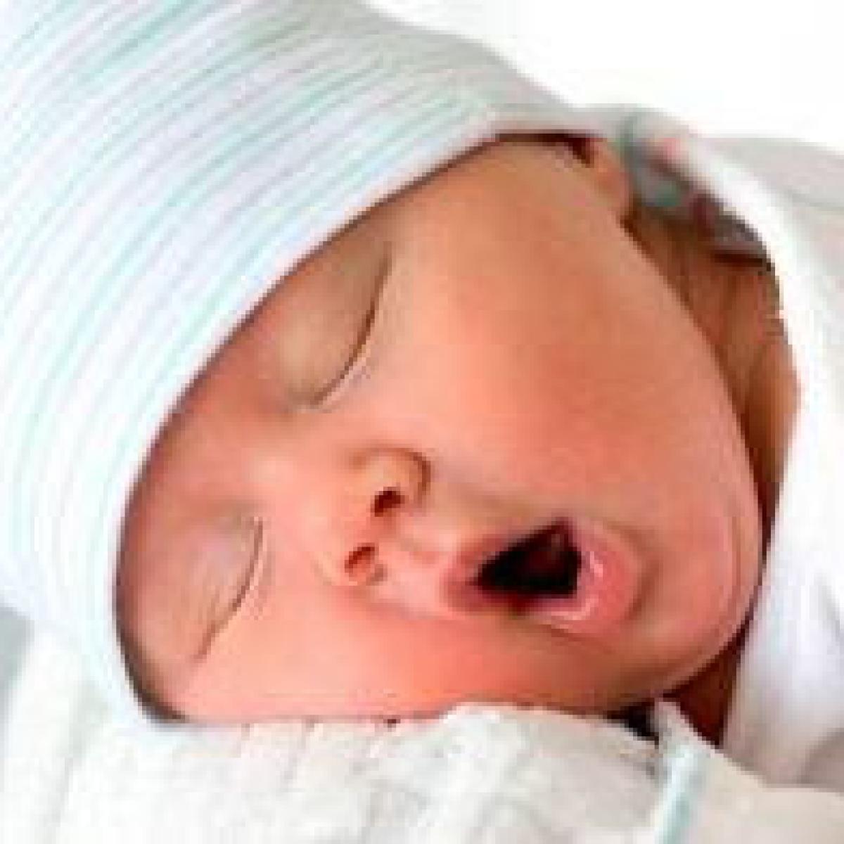 The face of a yawning baby